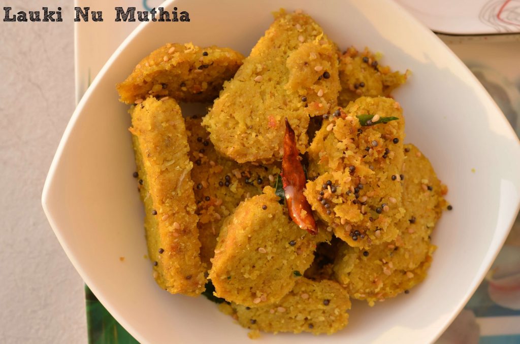 Lauki Ki Muthiya | Steamed Bottle Gourd Dumplings Lauki Nu Muthia or lauki muthia or bottle gourd's steamed dumplings is a popular Gujarati tea time snack, having less oil but very tasty and nutritious. Muthi means fist, this snack is named as muthia because we have to shape them in a cylindrical shape with the help of fist. Lauki Nu Muthia is a very healthy snack as it is steamed. You can shallow fry as well if needed.