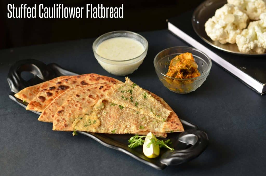 Gobhi Paratha or Stuffed Cauliflower Flatbread gobi paratha served with curd, pickle along with lemon wedges.