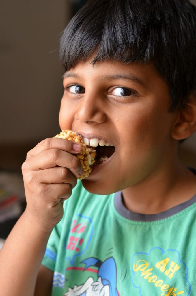 Murmura Laddu Recipe | Puffed Rice Sweet Balls laddu my son eating a bite from the murmura laddo