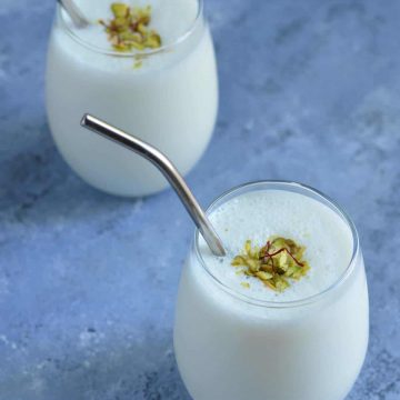 Lassi served in glasses, garnished with dry fruits