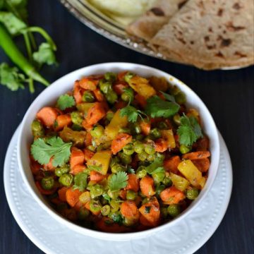 Gajar Matar sabji is a dry mix of carrots and peas sauteed in oil with spices. A very simple dish to use all seasonal veggies and create a flavorful dish. This gajar matar ki sabji is cooked mostly in winters because that's when fresh carrots and peas are available in the market.