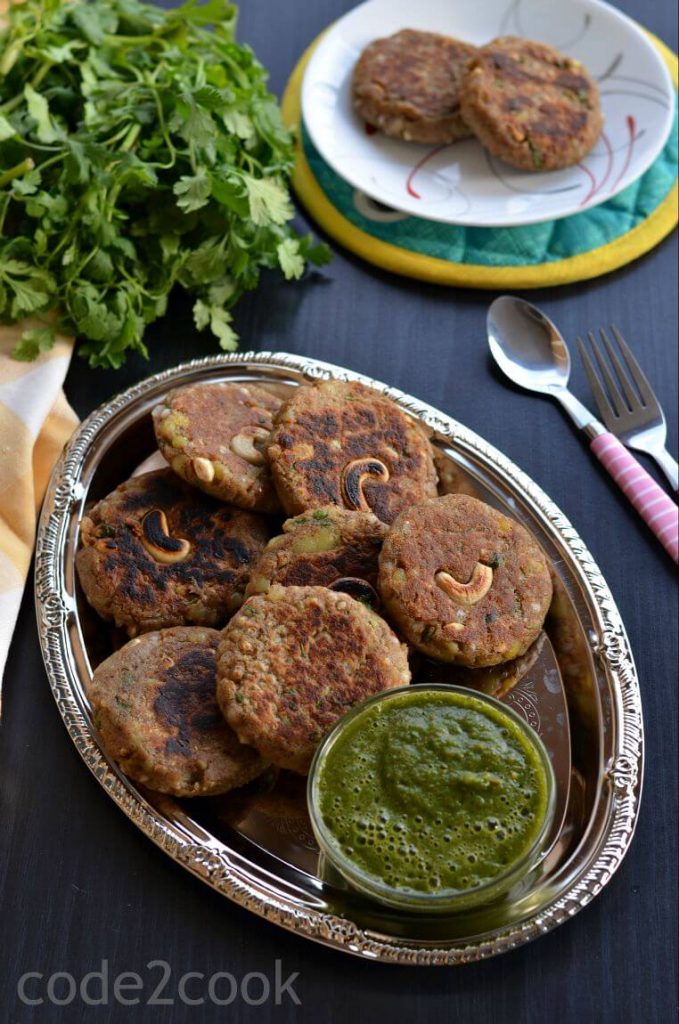 Kuttu Ki Tikki | Buckwheat Cutlet Recipe | Buckwheat Potato Croquette Kuttu ki Tikki or buckwheat cutlets are served with coriander chutney in a silver plate.