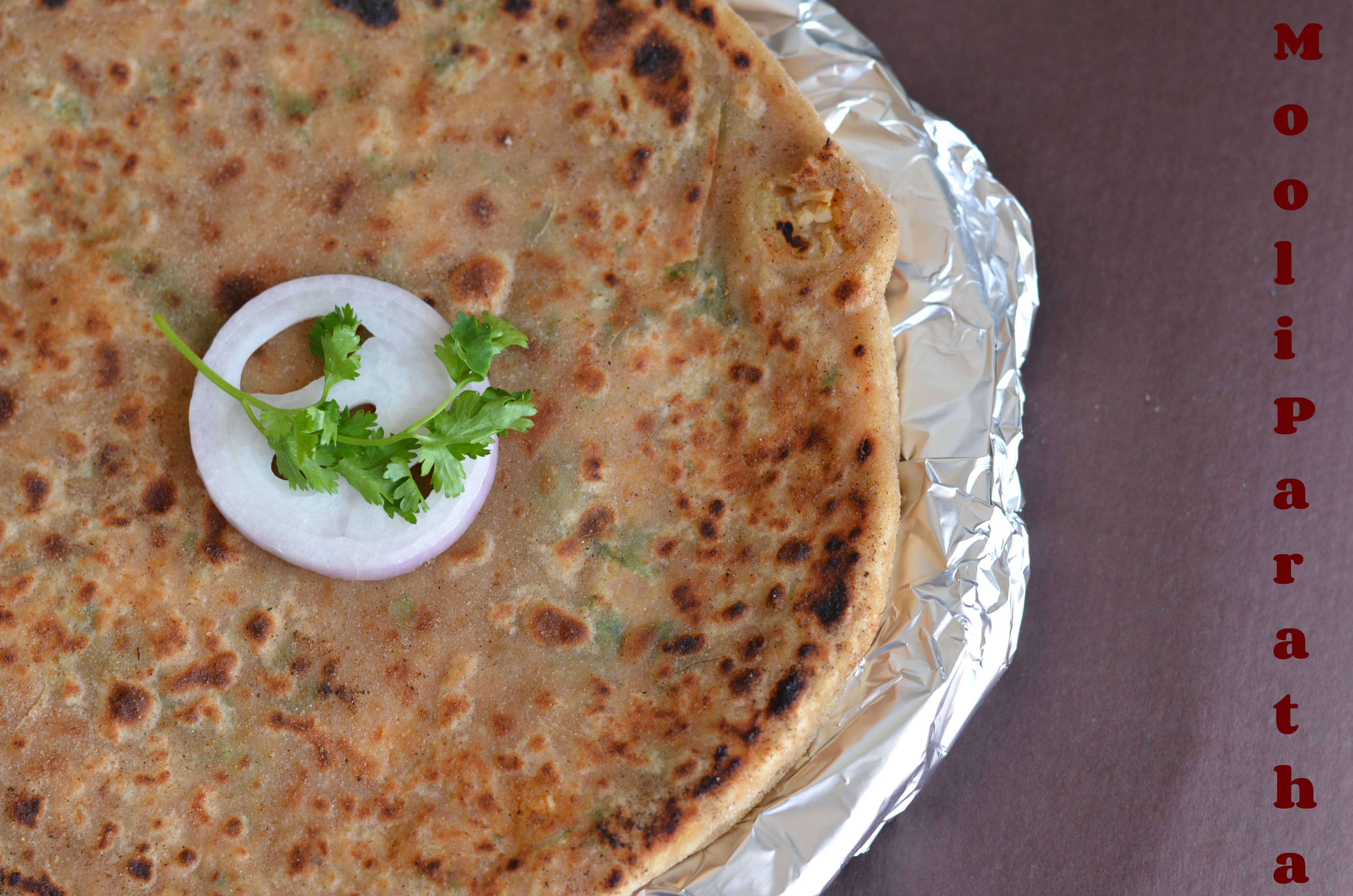Mooli Paratha Recipe | Stuffed Radish Flatbread Mooli paratha or radish paratha is an Indian flatbread stuffed with grated radish. Stuffing is spiced up with few spices and then stuffed in whole wheat dough portions. These parathas make a wholesome meal for breakfast, lunch or dinner.