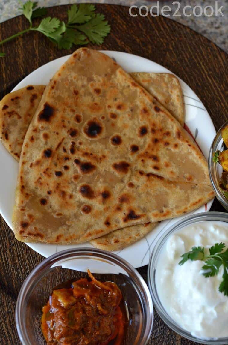 A close up of Ajwain paratha served with pickle & curd