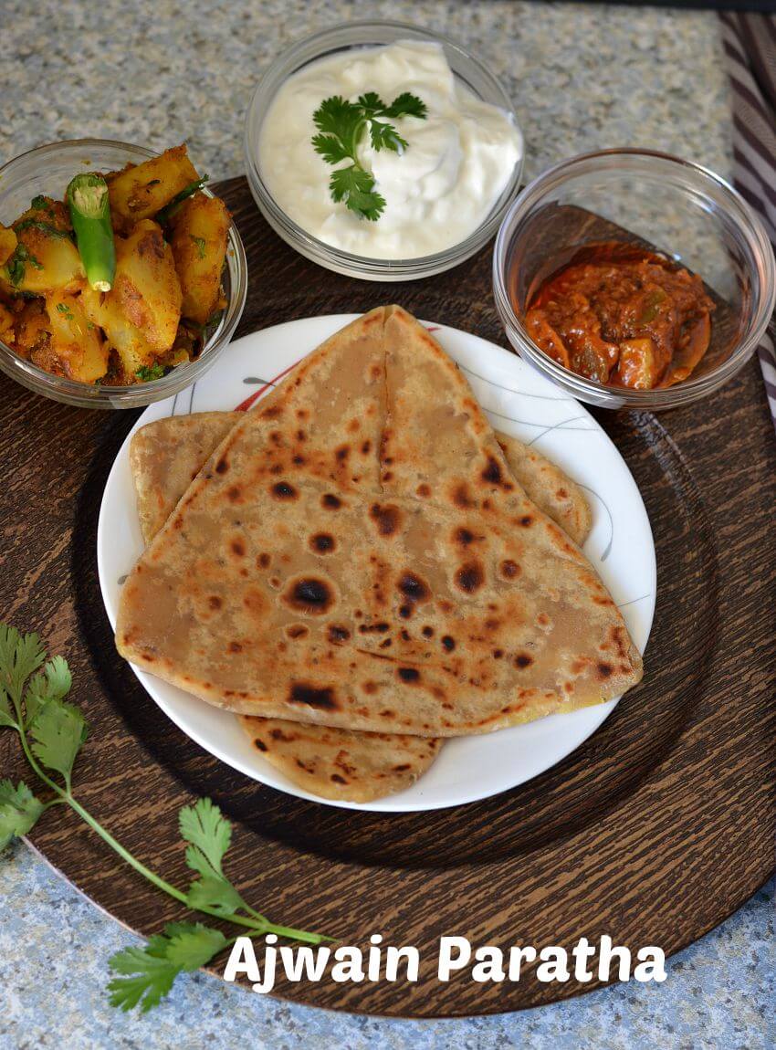 Ajwain paratha served with aloo sabji, curd and pickle.
