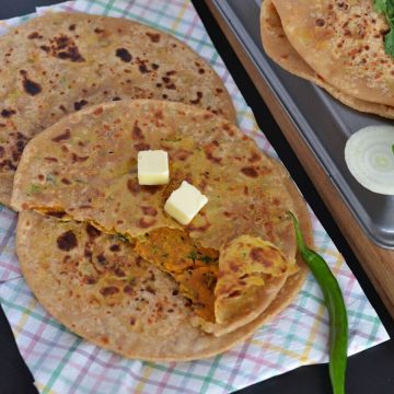 Besan paratha or masala besan paratha is a wonderful Rajasthani paratha recipe which is prepared by stuffing spicy besan or gram flour filling in the whole wheat dough. This paratha is crispy, aromatic and filled with the pickled flavor besan stuffing makes a wholesome meal.
