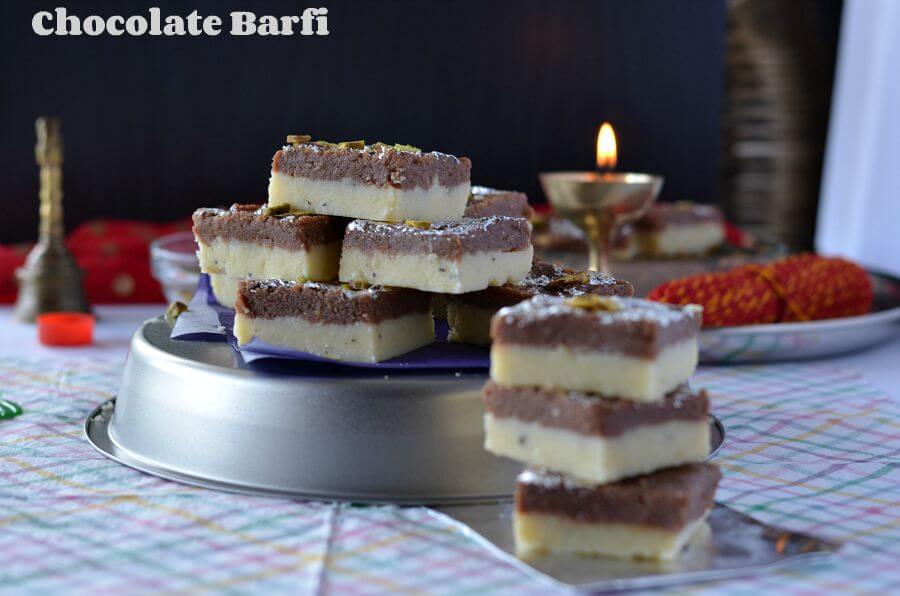 Chocolate burfi is one of the popular Indian festival sweet prepared during Diwali. It is a khoya burfi or mawa burfi recipe. Chocolate burfi is two layered burfi recipe, where the bottom layer is plain mawa layer and the top layer is chocolate flavored.