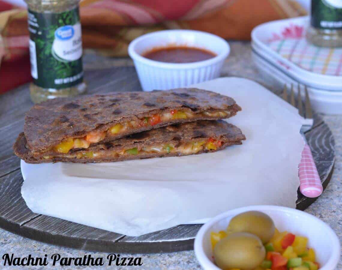Nachni Pizza Paratha | Pizza Paratha | Healthy And Nutritious Finger Millet Flour Pizza Paratha Pizza paratha is a stuffed flatbread which tastes like pizza and popular among kids. It is a fusion between paratha (Indian flatbread) and Italian Pizza. Basically, it is an Indian paratha (flatbread), which is stuffed with pizza sauce and vegetables filling with cheese. Cooked on the stove top like a paratha.