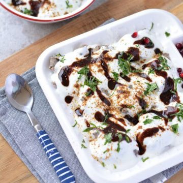 Kuttu ka dahi Bhalla or vrat ka dahi vada made with buckwheat flour and then combined with beaten curd/yogurt, vrat ki chutney, cumin seed powder, and green coriander.