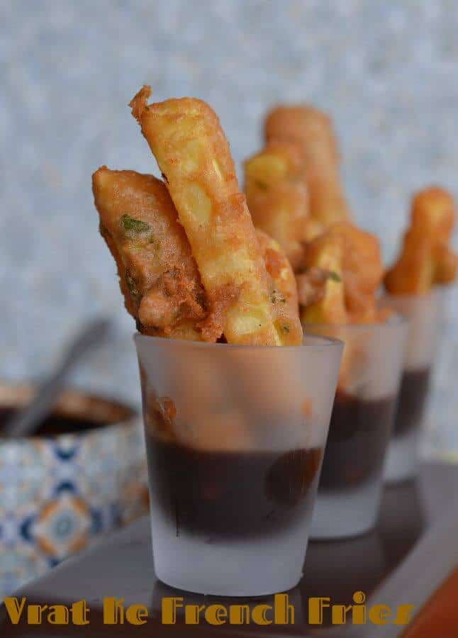 Farali French Fries | Vrat Ke French Fries | Rajgira Flour French Fries a close up shot of farali french fries in a mini glass with tamarind chutney.