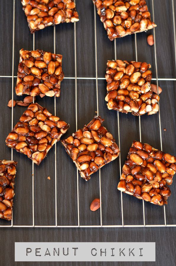 Dry Fruit Chikki | Peanut Chikki | Mixed Nut Chikki close up click for peanut chikki. Placed on rack and peanuts are scattered around.