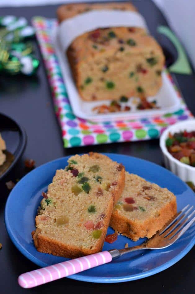 sliced tutti frutti cake served in blue plate.