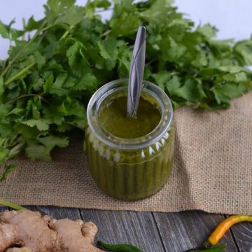 green chutney for chaat is served in glass jar. hari chutney or green coriander chutney