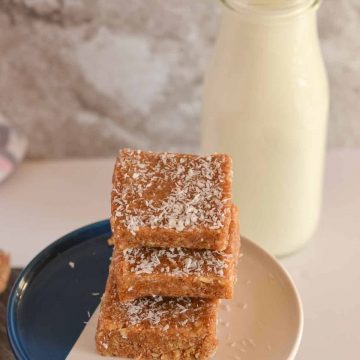 macadamia nut bars are stacked and placed over cookie stand.