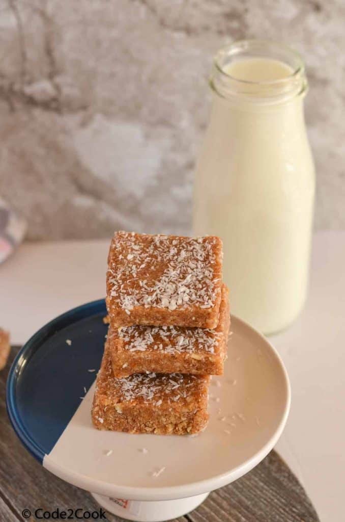 macadamia nut bars are stacked and placed over cookie stand.