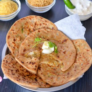 bhujia sev paratha on a plate and served with curd, namkeen.