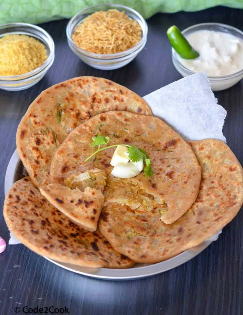bhujia sev paratha on a plate and served with curd, namkeen.
