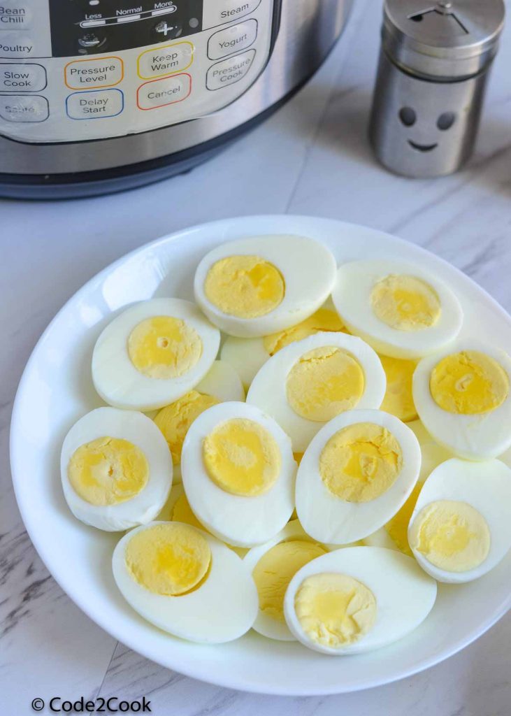 Boiled eggs cut into half and served in white plate.