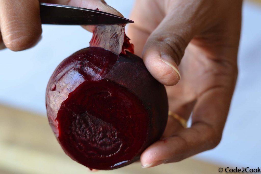 showing how to peel beetroot after steaming using knife