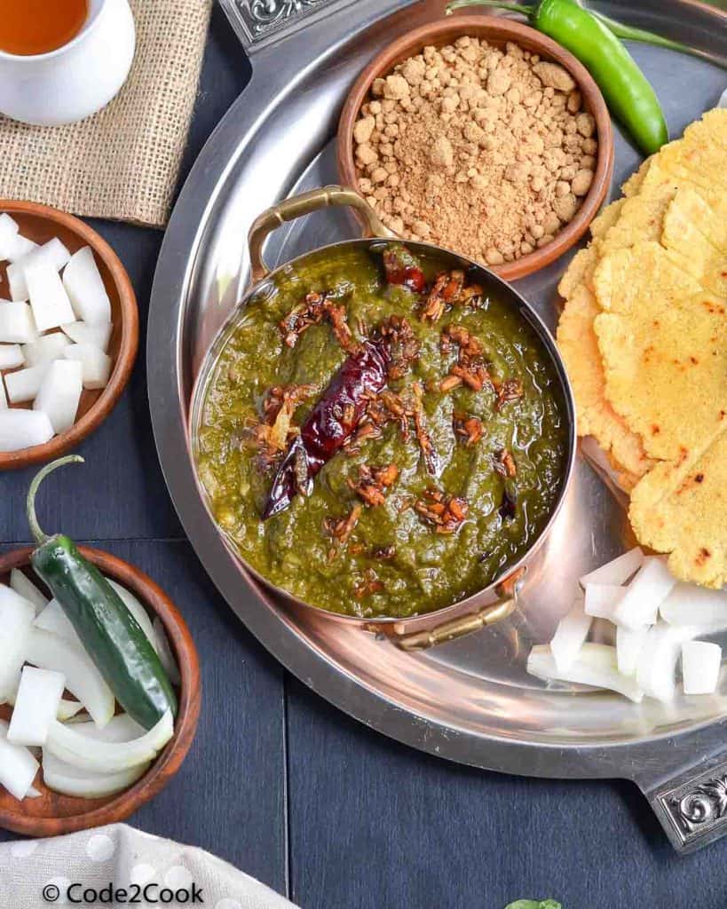 sarson ka saag platter with makki ki roti, ghee, radish, and jaggery