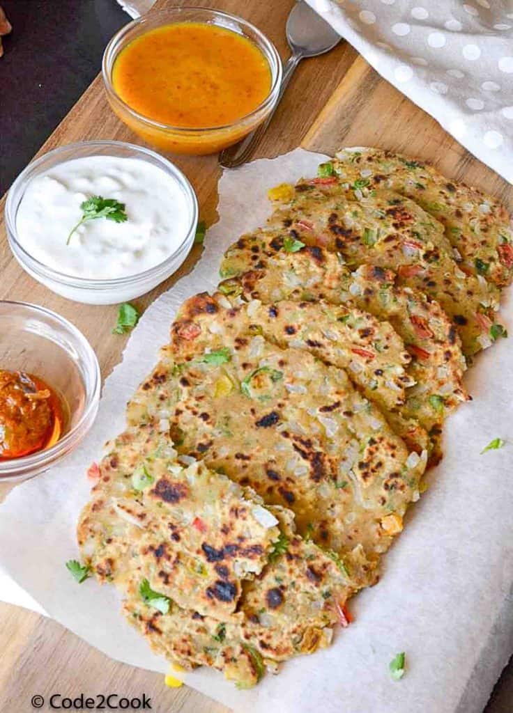 capsicum paratha served with chutney, curd and pickle.