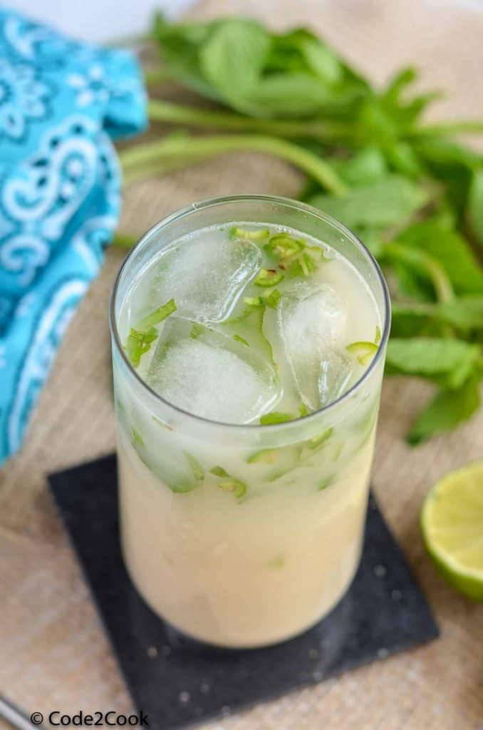 sattu sharbat in tall glass with ice cubes.